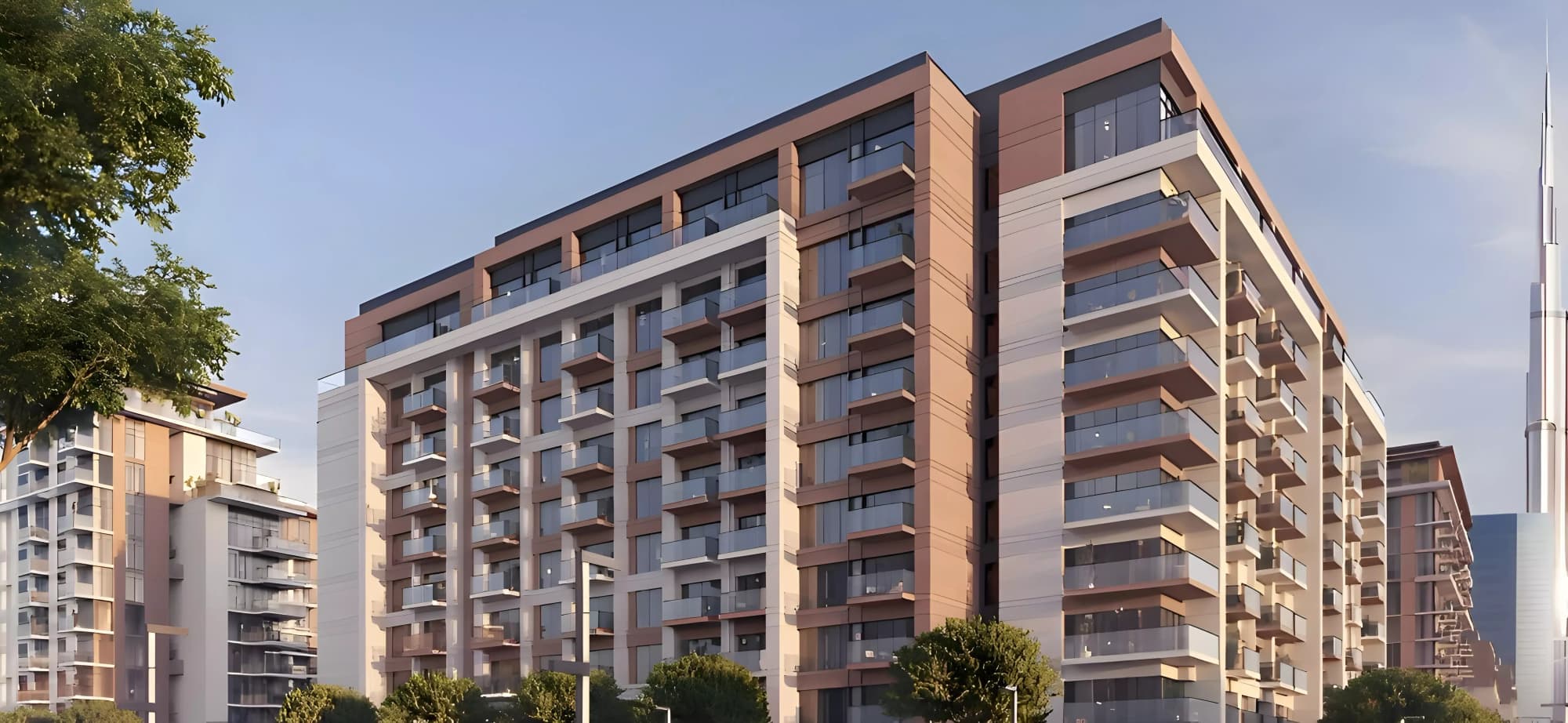 A residential apartment building with balconies and street trees, the Dubai skyline behind it